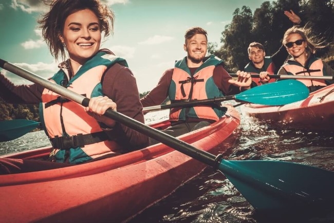 Happy people on kayaks