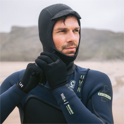 C-Skins NuWave natural rubber wetsuit worn by a surfer in cold water