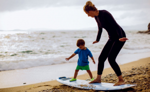 mum and child on a surfboard